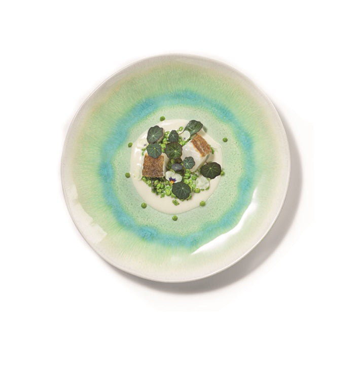 Formentera stoneware plate with green-blue glaze and wave textures, adding Mediterranean coastal elegance to dining.