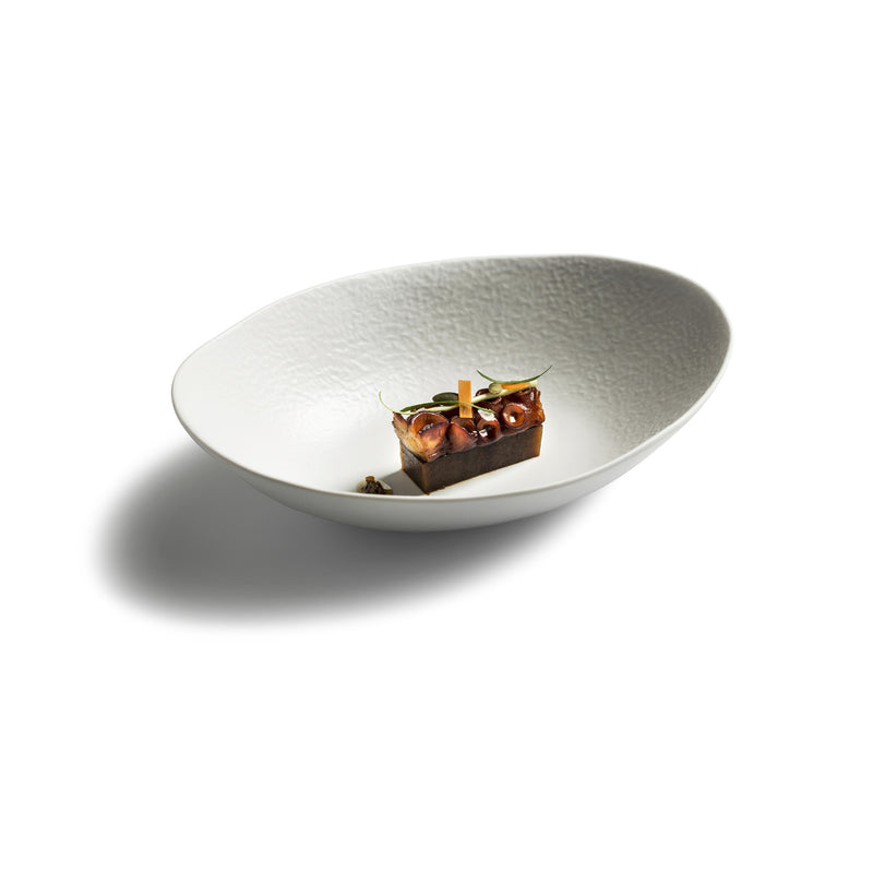 Artistic oval porcelain bowl with matte finish; luxury handmade tableware ideal for elegant plating and gourmet food presentation.