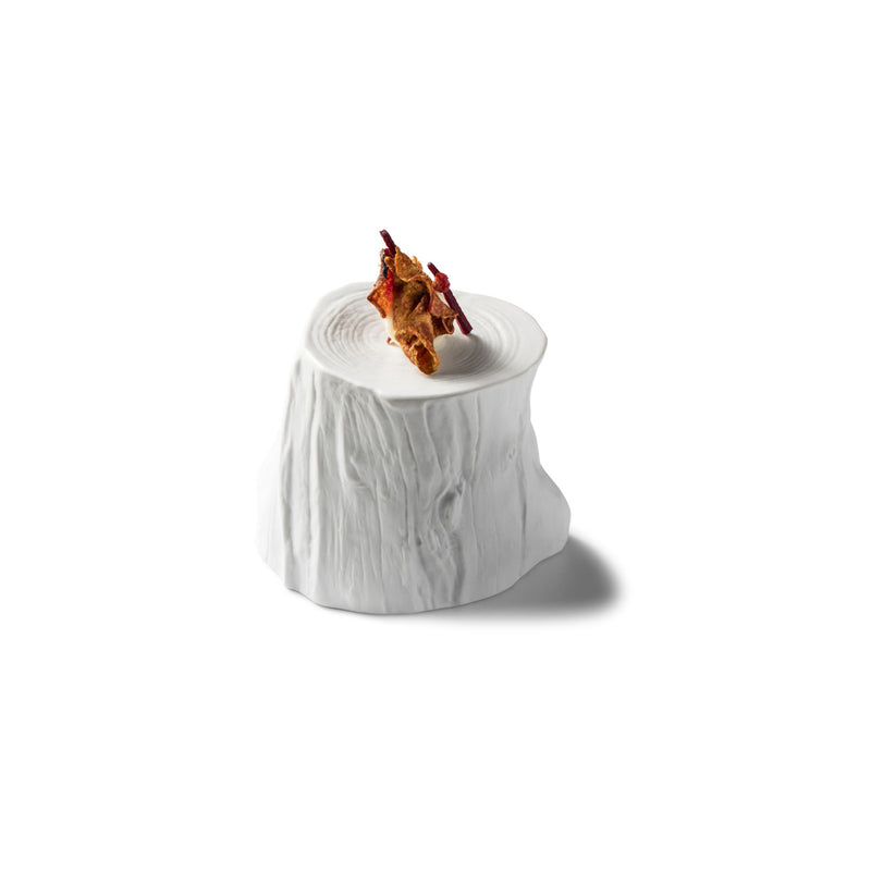 Artistic matte porcelain podium stand inspired by tree stumps; luxury tableware for elegant, single-dish presentation.