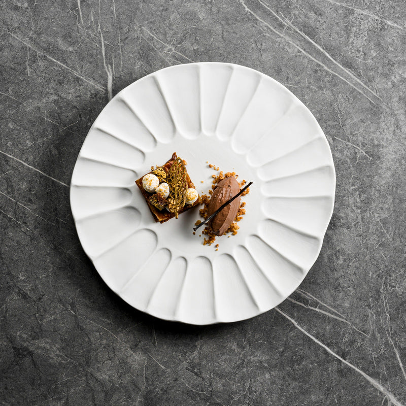 Lira plate in matte white porcelain with sculpted fluted design, luxury artistic tableware for elegant fine dining