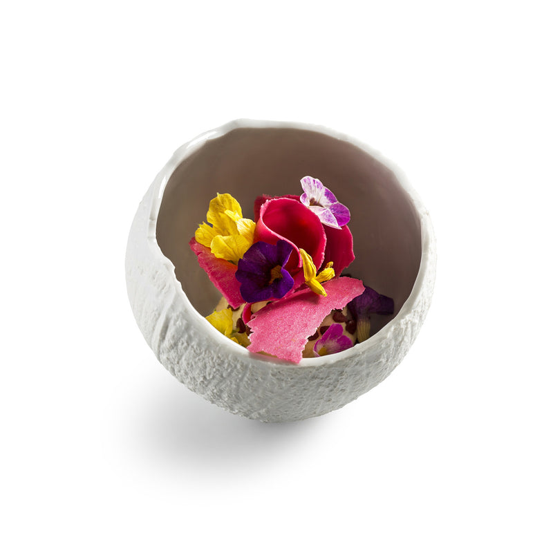 Porcelain coconut-shaped bowl with matte finish, exotic luxury tableware for tropical salads, fruits, and artistic dining presentations.