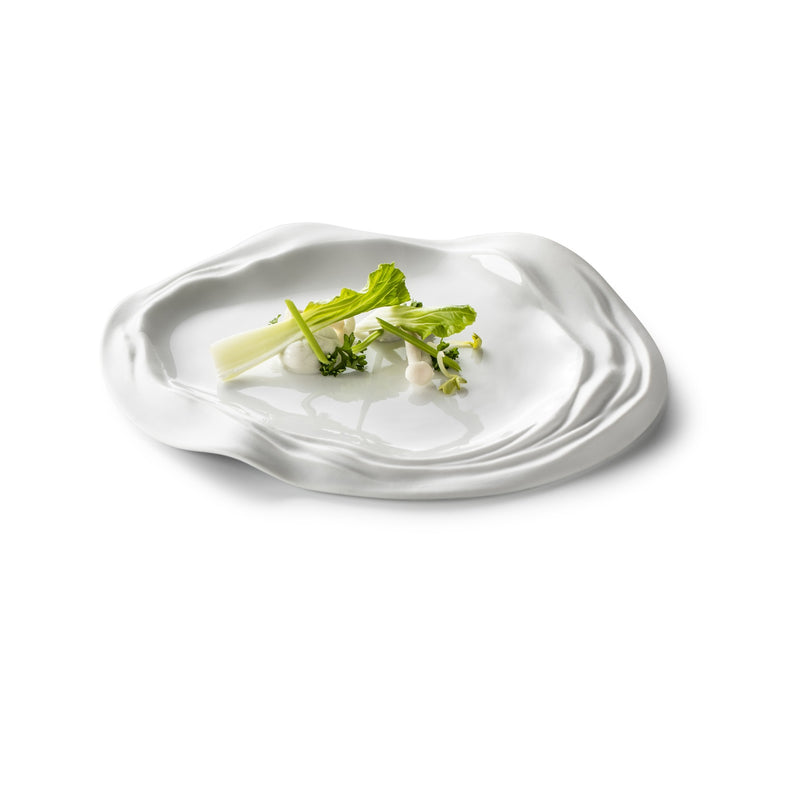 Porcelain plate with wave-edge design, matte-gloss finish; luxury artistic tableware inspired by Barcelona's elegance.