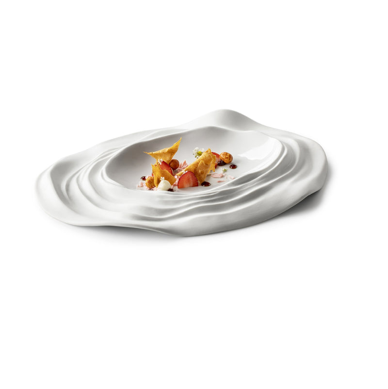Luxury porcelain oval plate with wave-textured matte-gloss finish, inspired by Barcelona’s artistic coastal design.