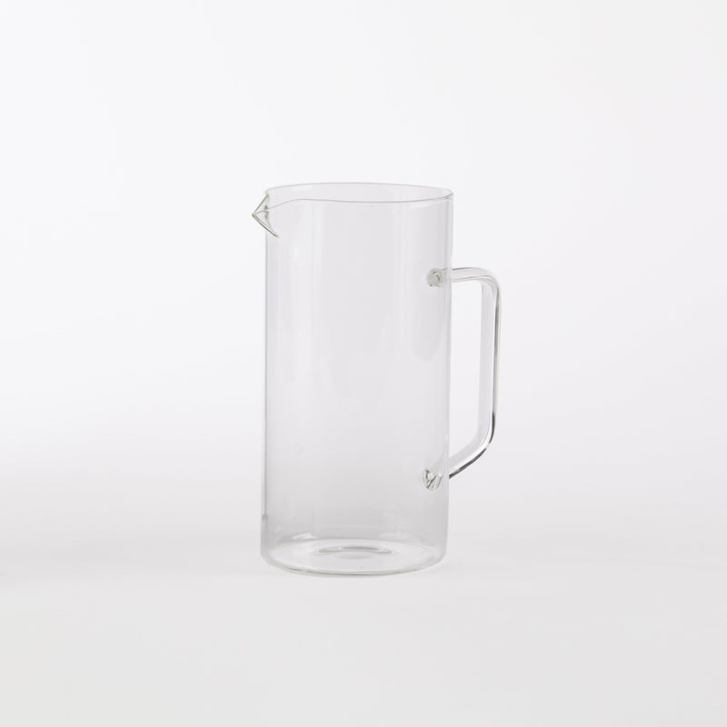 Clear borosilicate glass pitcher with handle and spout, minimalist drinkware for water, juice, or table service.