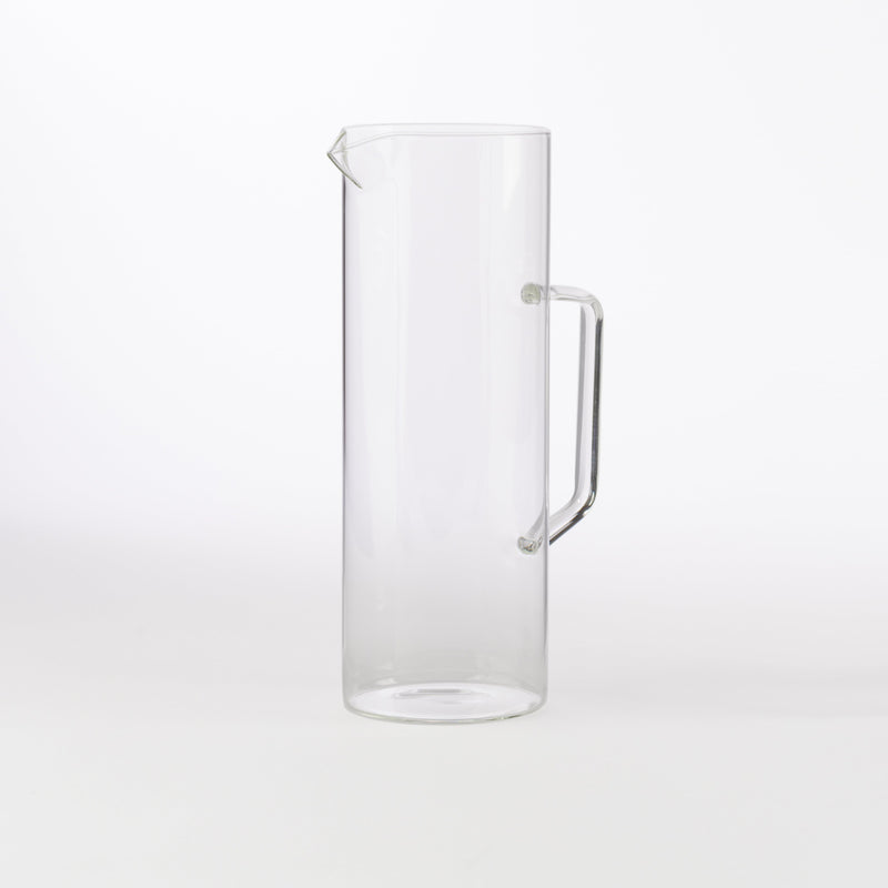 Clear borosilicate glass pitcher with handle and spout, minimalist drinkware for water, juice, or table service.